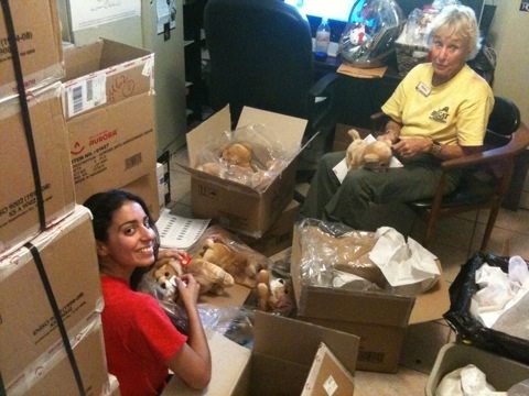 Phil and new Red shirt volunteer unpacking boxes in gift shop
