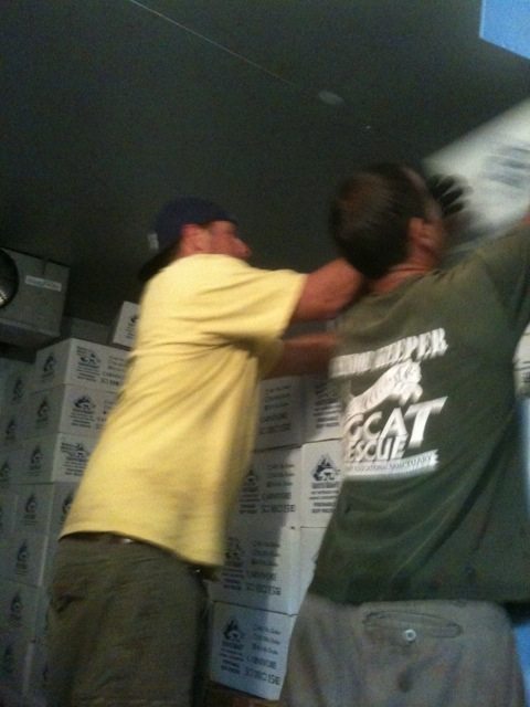 Darren and Jarrod organize the stacks to make room for the new meat delivery