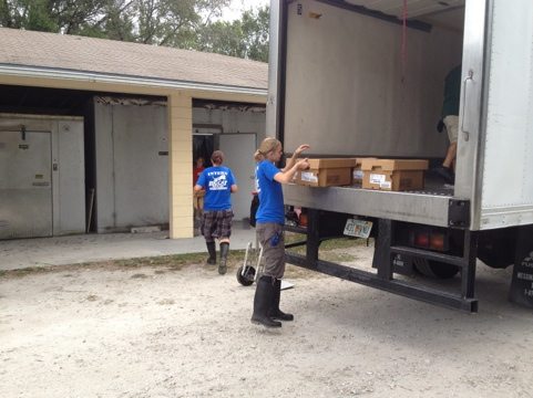 Meanwhile a truckload of meat arrives so volunteers and interns unload