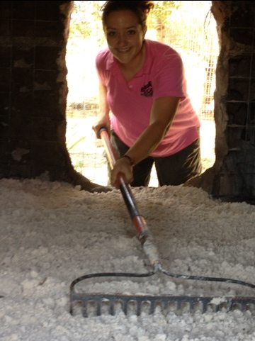 Pres Jamie Veronica spreads out the new sand in den for tiger