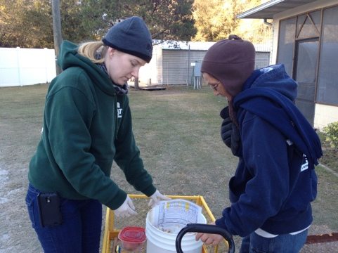 Chelsea and Gale prepare to feed cats in the chilly 40 degrees