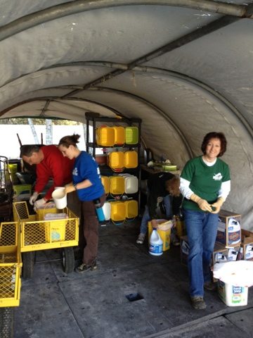 Volunteers get ready for cleaning by loading up buckets, tongs, bags
