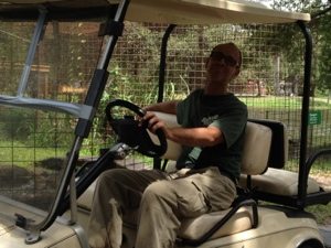 Green Level Rich Bluder drives by on golf cart