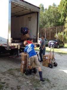 Volunteers unload the meat truck